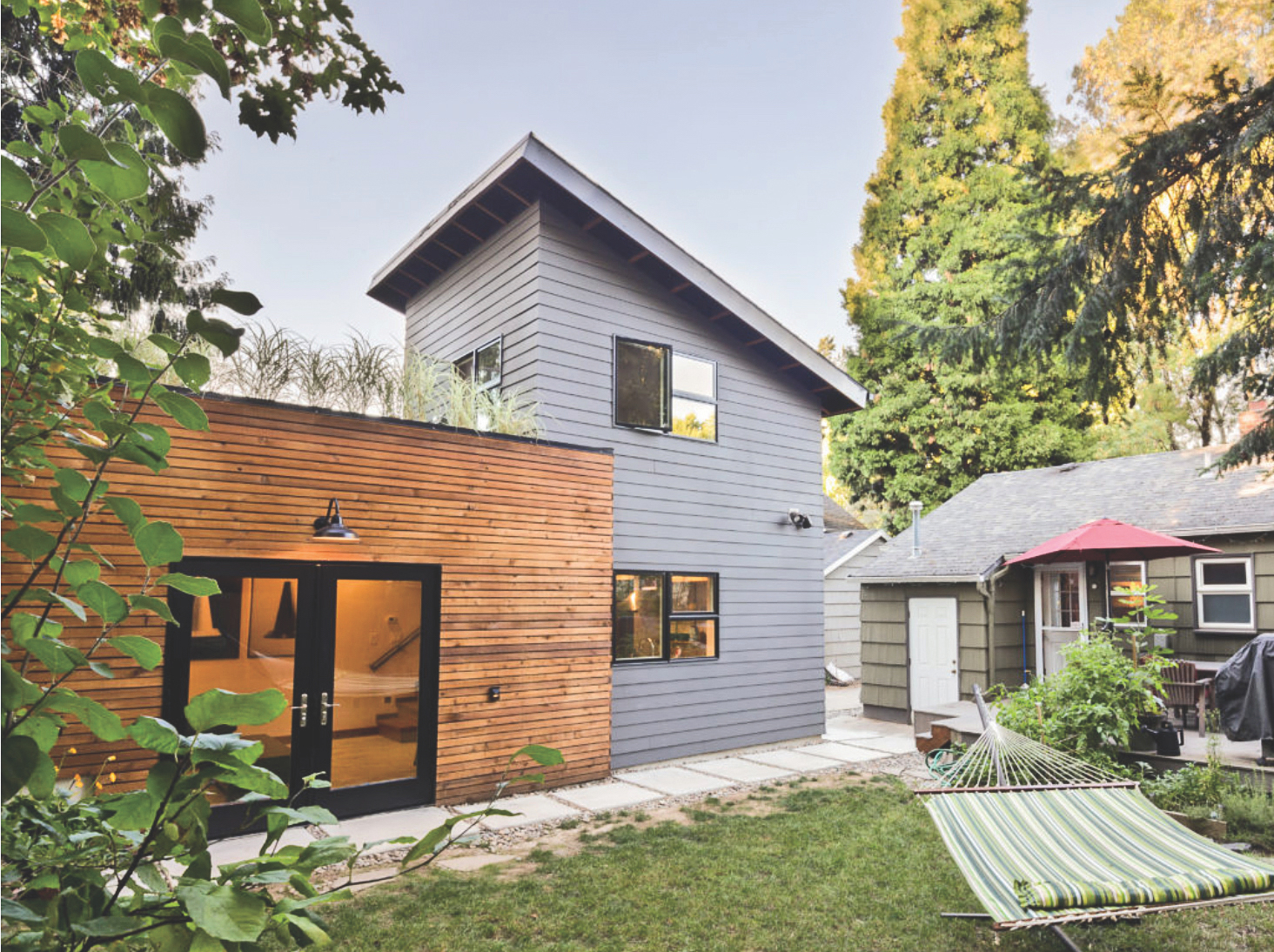 Sleekly designed two-story accessory dwelling unit behind a house